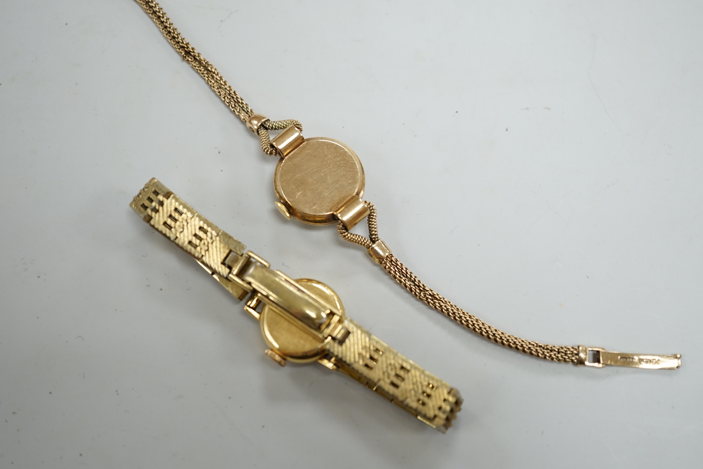 A lady's 9ct gold Omega manual wind wrist watch, on a gold plated bracelet, together with a lady's 9ct gold manual wind wrist watch, on a 9ct gold bracelet.